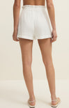 White shorts worn by a person on a plain background