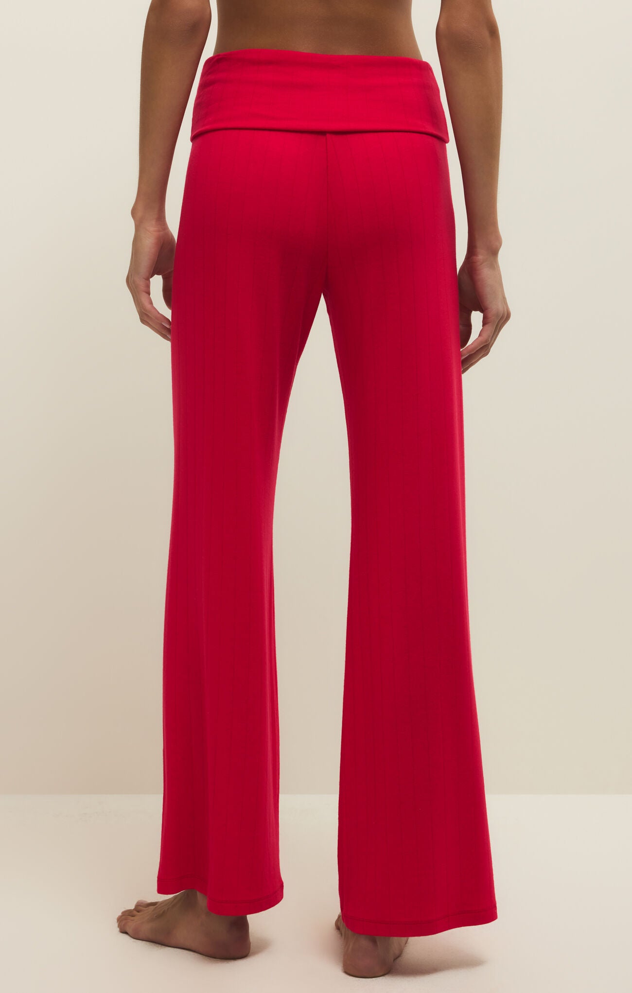 Red pants worn by a person on a plain background
