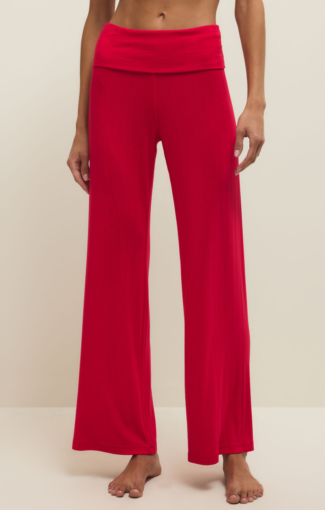 Red pants worn by a person on a plain background