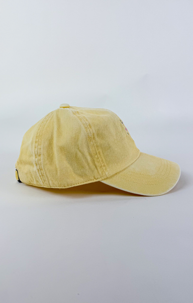 Butter yellow baseball cap with a small embroidered pink and purple flower bouquet centered on the front.