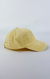 Butter yellow baseball cap with a small embroidered pink and purple flower bouquet centered on the front.