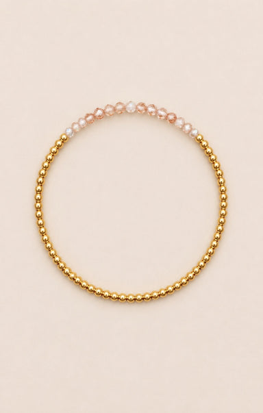 gold bracelet on neutral background