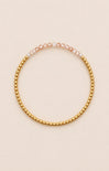 gold bracelet on neutral background