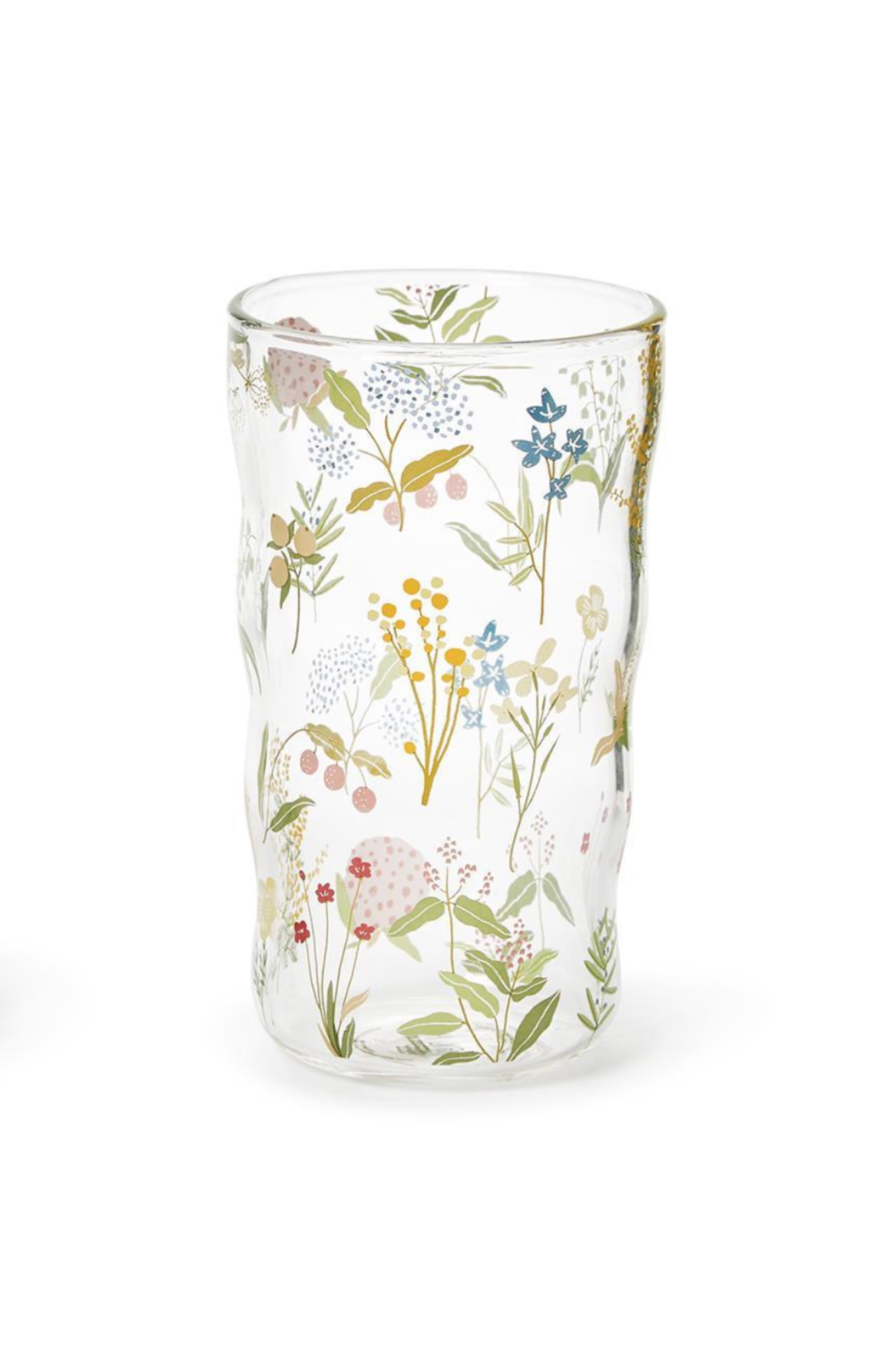 Clear glass tumbler with floral design on a white background