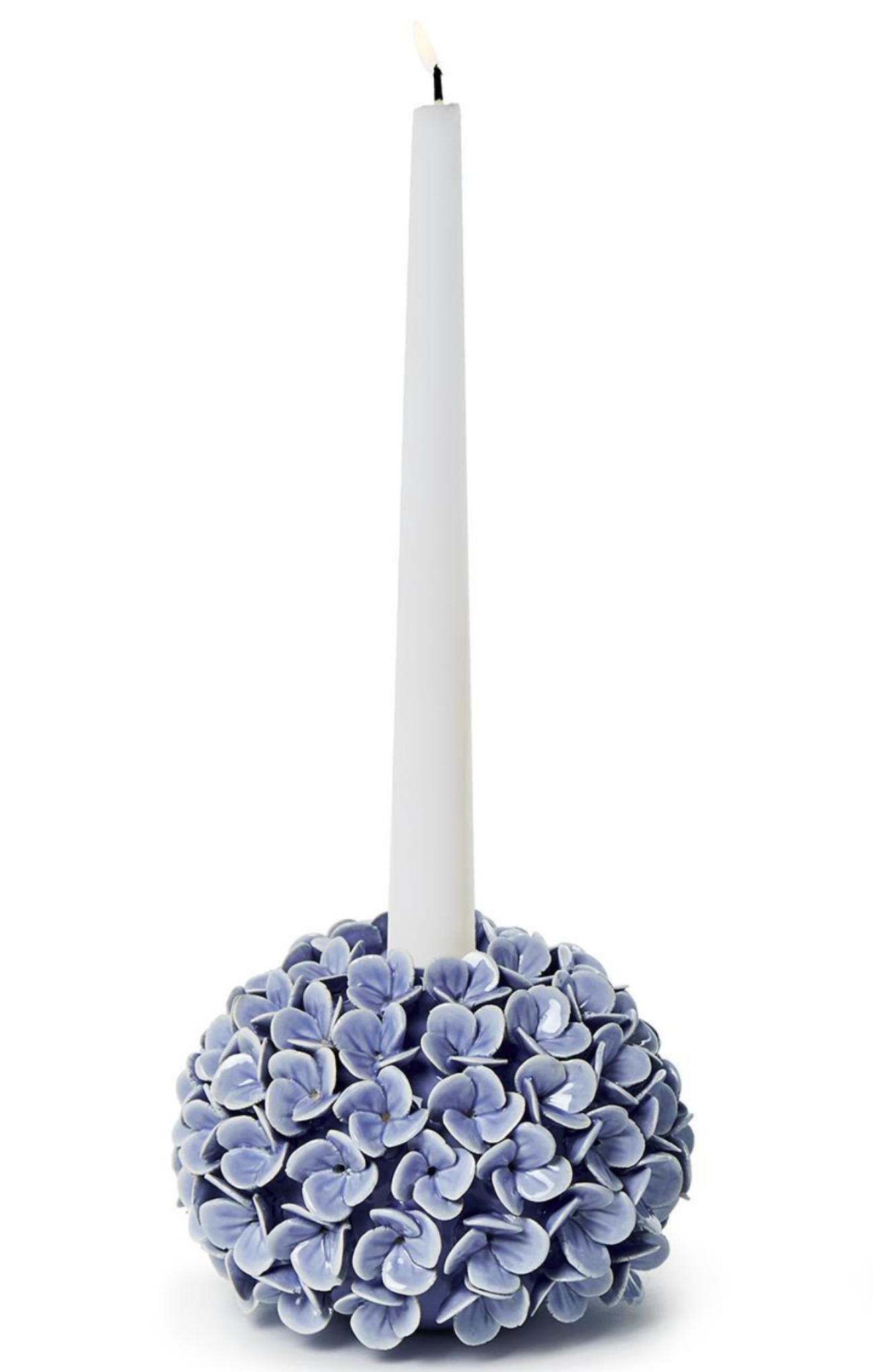 Decorative candle holder with blue floral design holding a white candle on a white background