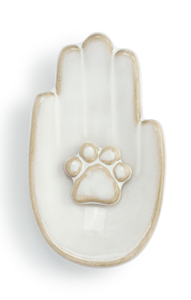 Decorative ceramic hand with a paw print on a white background