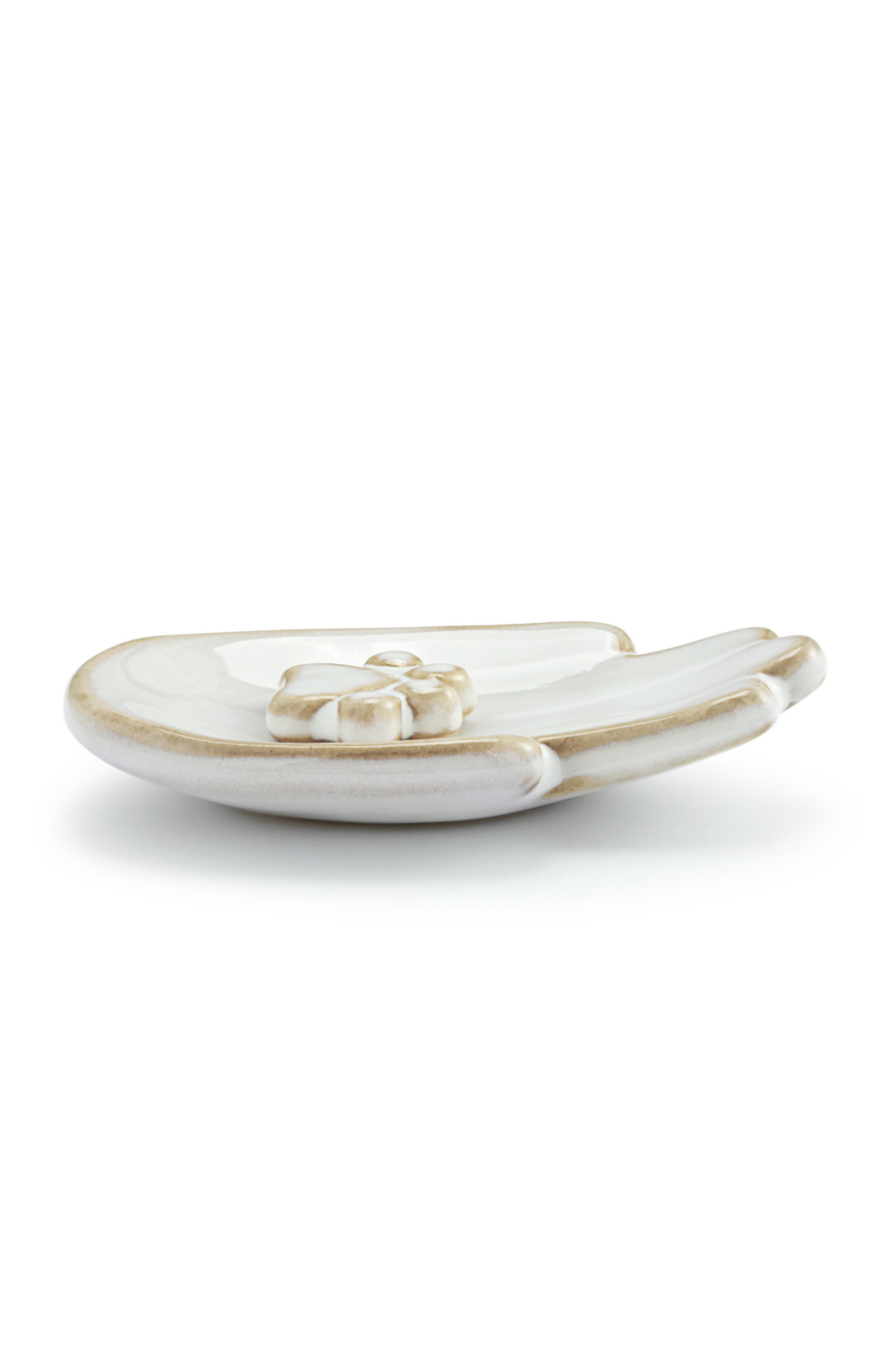 White ceramic dish with gold rim on a white background