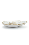 White ceramic dish with gold rim on a white background