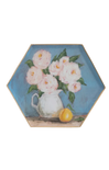 Decorative plate with a hexagonal design featuring a woman holding flowers and a lemon on a white background.