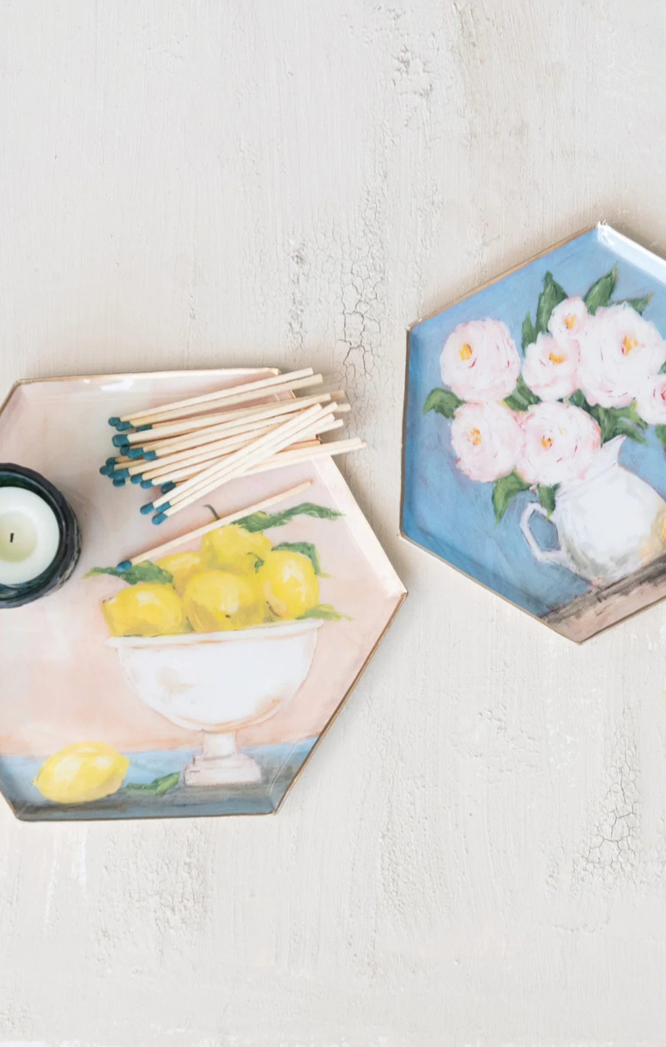 Hexagonal coasters with floral and lemon designs on a light surface