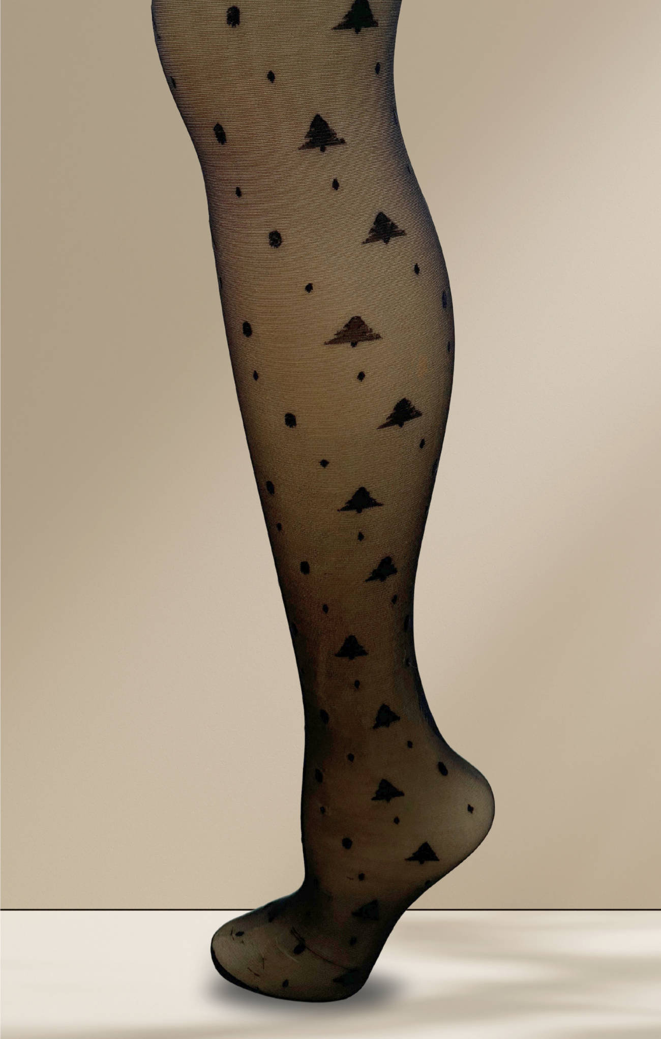 Black patterned tights on a beige background