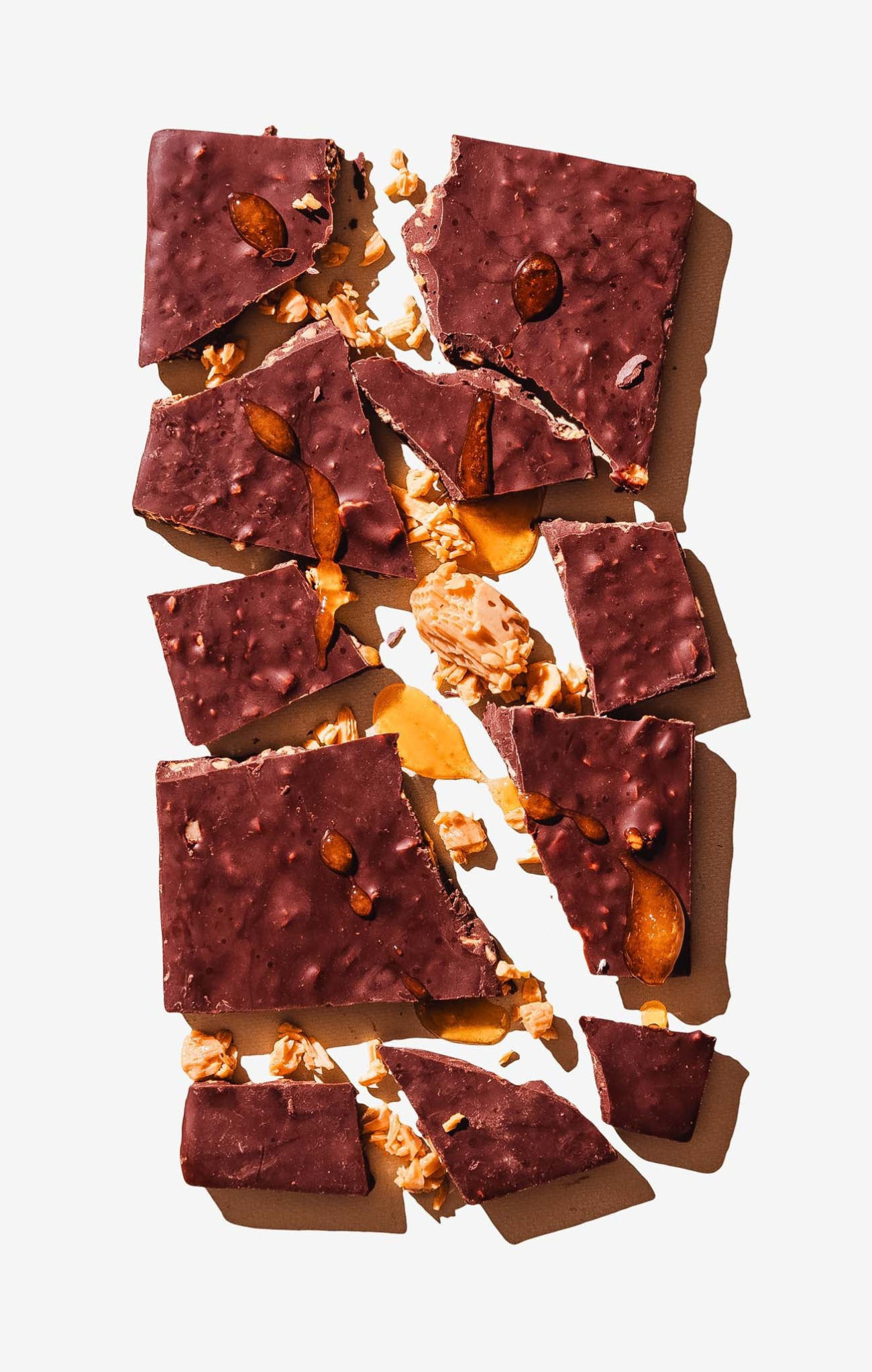 Chocolate bark with nuts and caramel on a white background