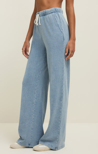 Light blue wide-leg jeans worn by a person on a neutral background