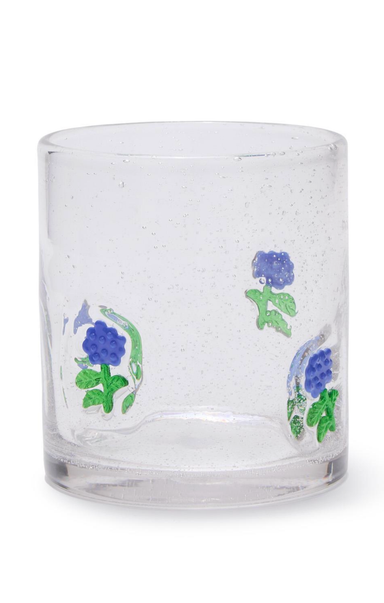 Clear glass tumbler with blue floral designs on a white background