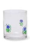 Clear glass tumbler with blue floral designs on a white background