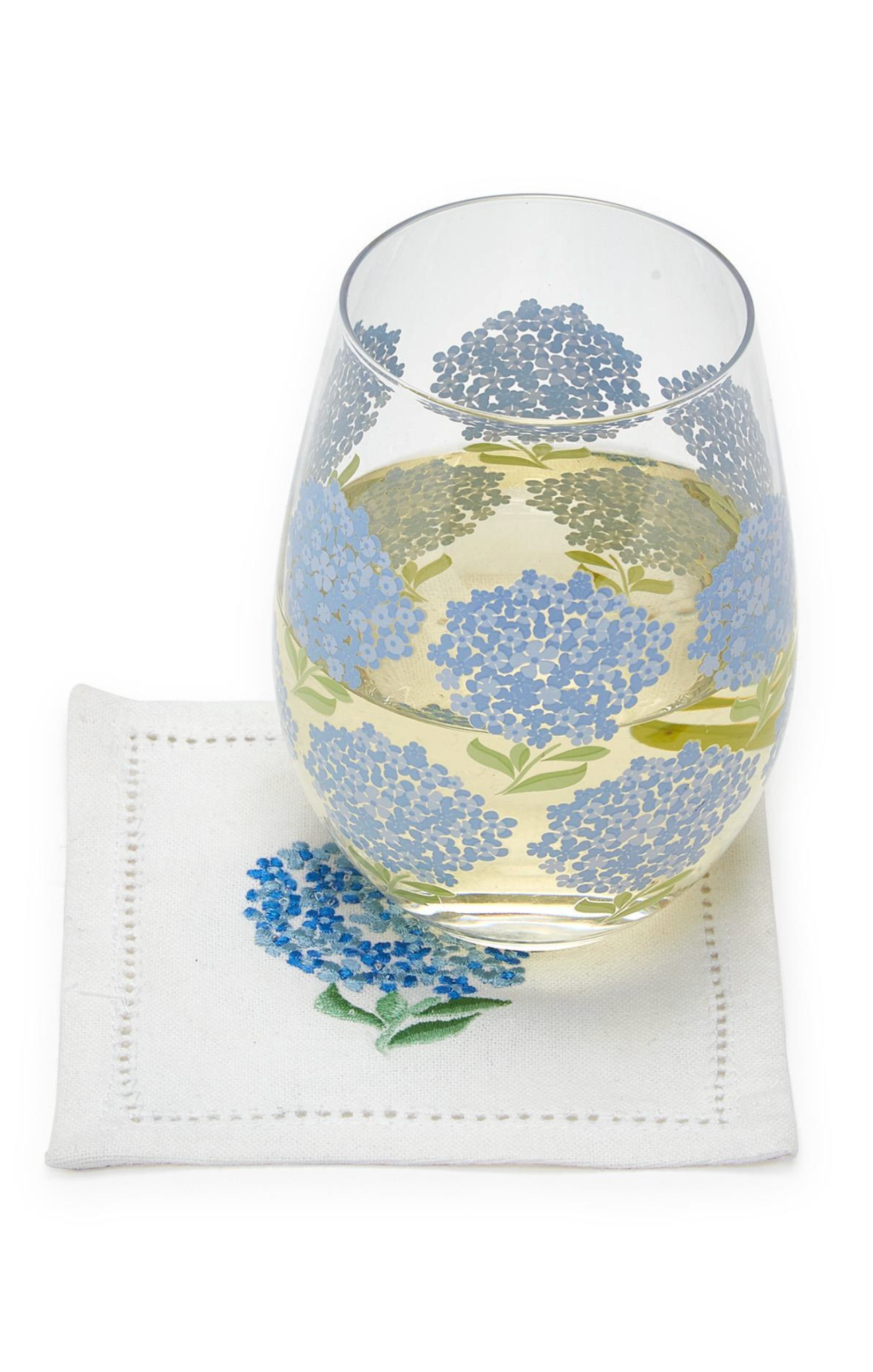 Glass with floral design on a white napkin