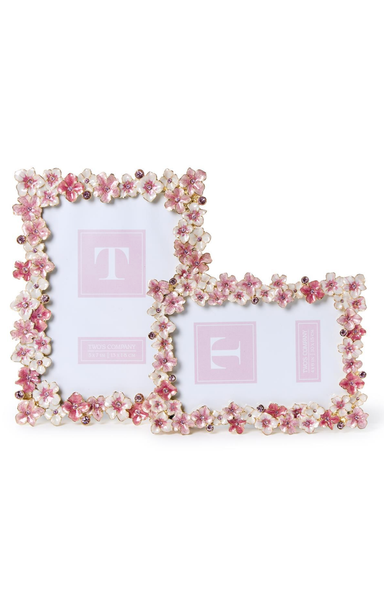 Two decorative photo frames with floral embellishments on a white background