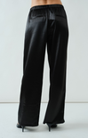 Black wide-leg pants worn by a person on a light gray background
