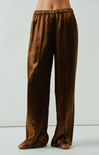Brown satin pants on a plain background