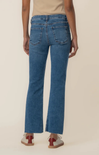 Person wearing blue jeans on a beige background