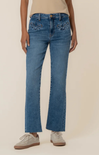 Person wearing blue jeans on a beige background