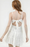 White lace dress with cut-out back on a white background
