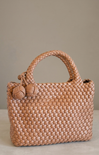 brown woven bag on neutral background