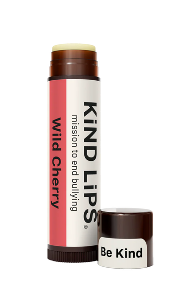 Lip balm with 'Kind Lips' branding and 'Wild Cherry' flavor on a white background
