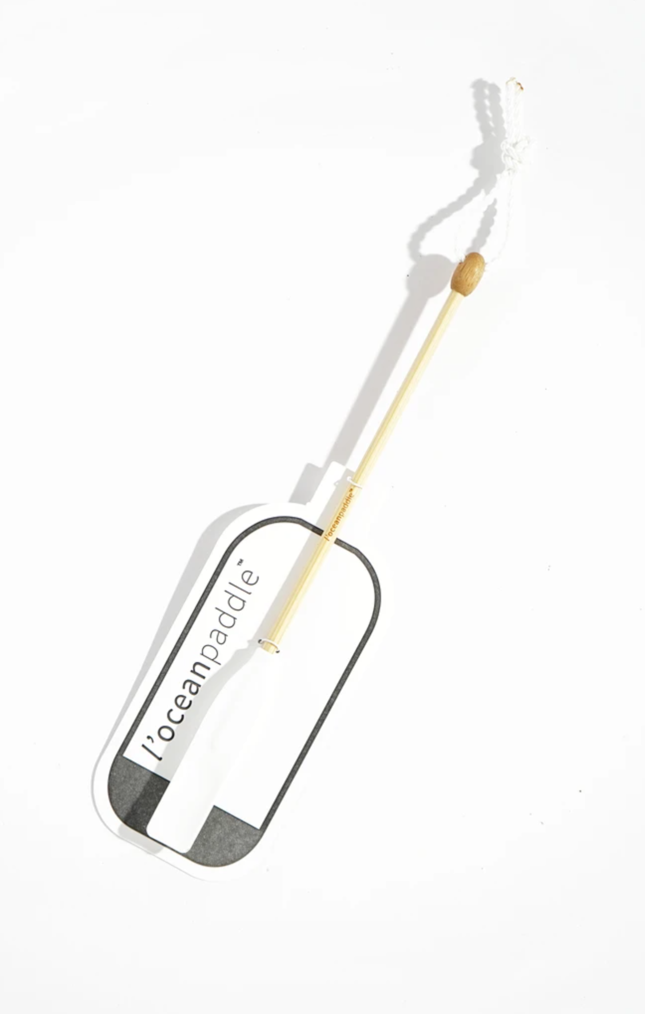 Paddle with a white handle and black blade on a white background