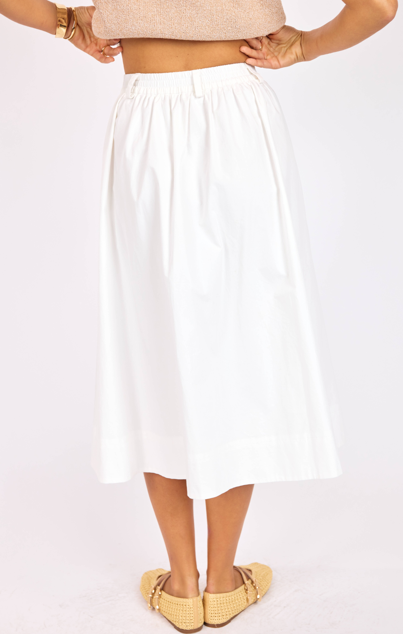 White skirt worn by a person on a white background