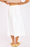 White skirt worn by a person on a white background