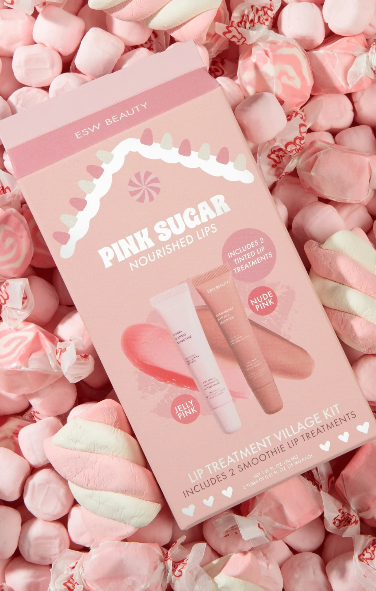 Pink Sugar lip treatment village kit on a bed of pink candies