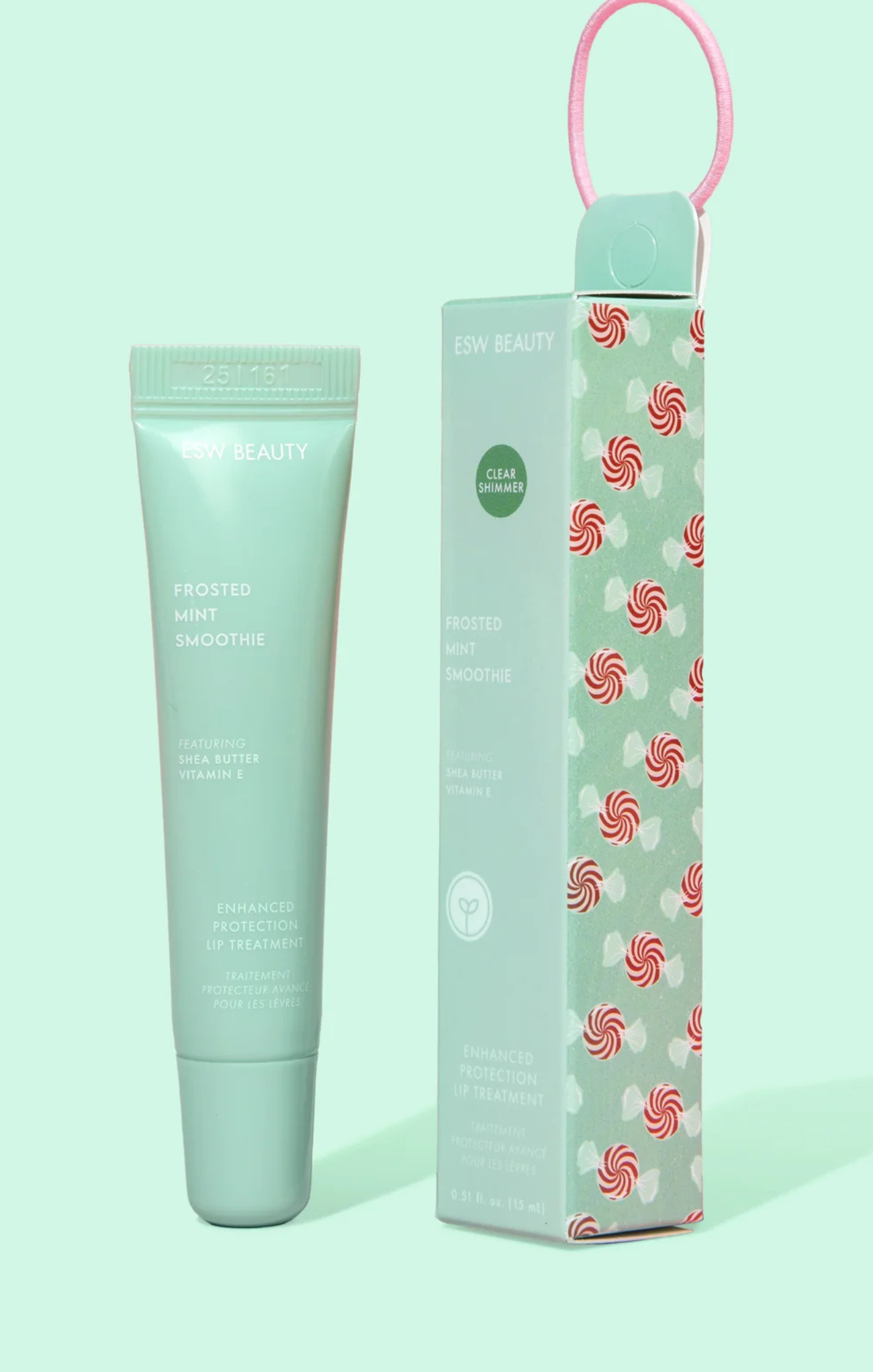 Mint green skincare tube and box with candy swirl design on a light green background