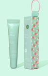 Mint green skincare tube and box with candy swirl design on a light green background