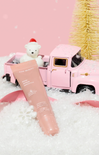 Pink bath bomb with a toy truck and teddy bear in the background