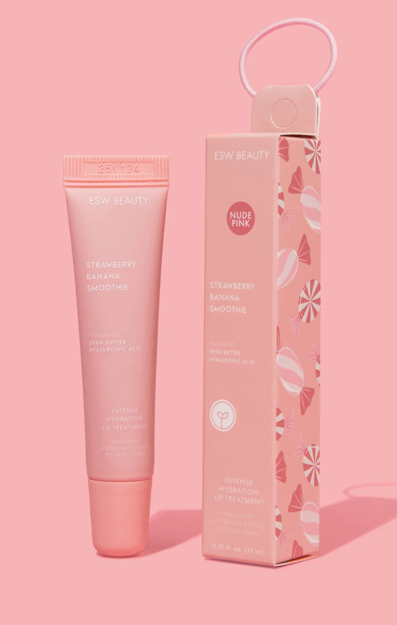 Pink skincare product with packaging on a pink background
