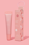 Pink skincare product with packaging on a pink background