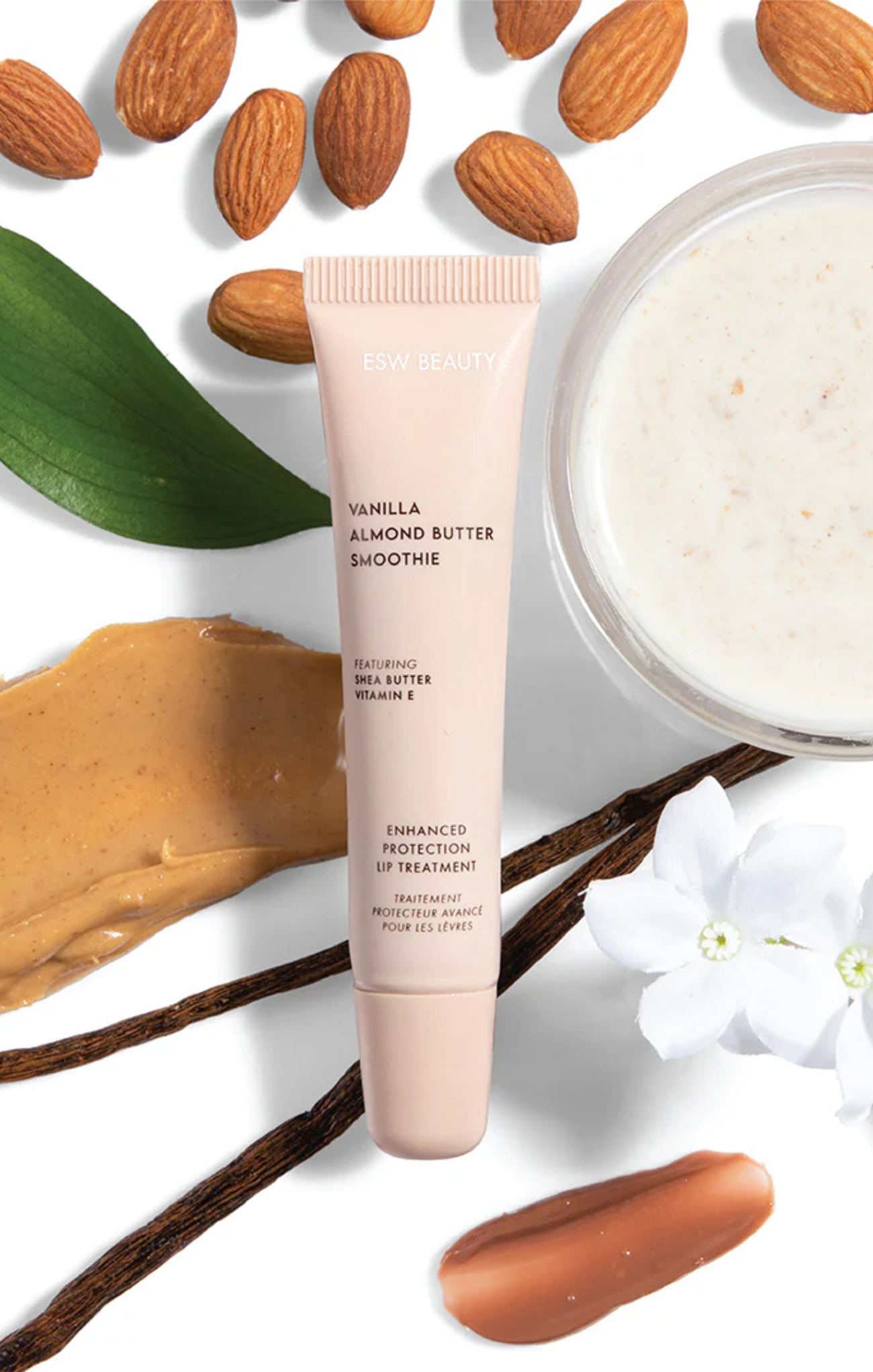 Vanilla Almond Butter Smoothie skincare product with almonds and a leaf on a white background