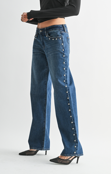 Blue jeans with decorative buttons on a white background