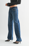 Blue jeans with decorative buttons on a white background