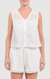White sleeveless top and shorts set with lace details on a plain background