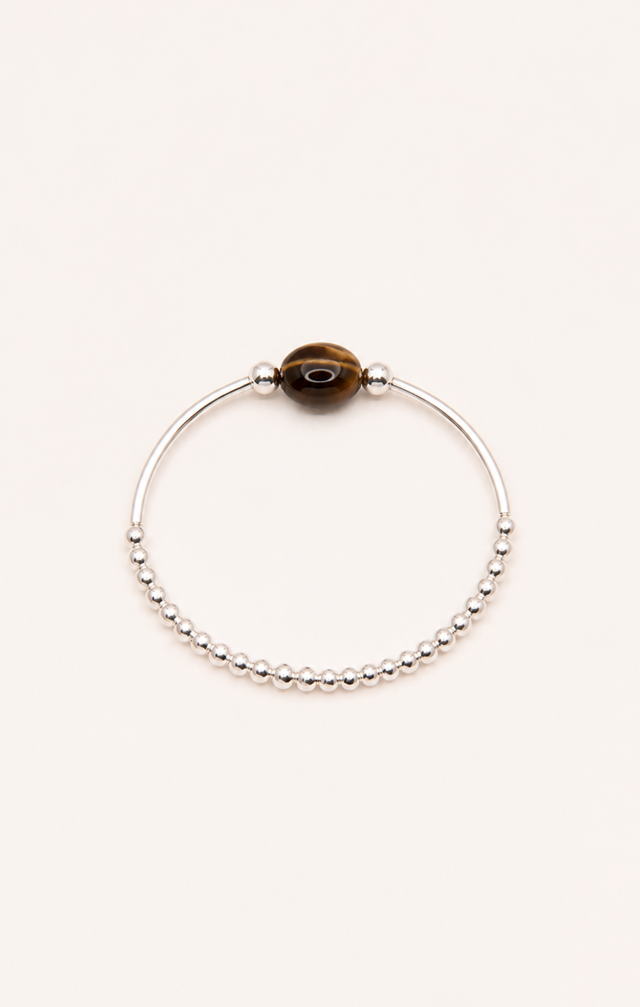 Silver bracelet with a brown bead on a white background