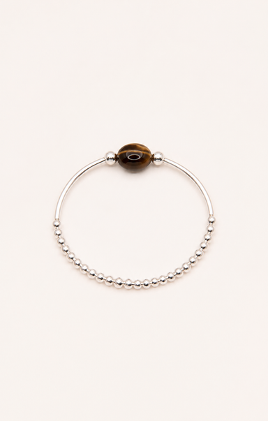 Silver bracelet with a brown bead on a white background