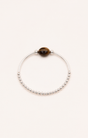 Silver bracelet with a brown bead on a white background