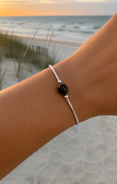 women wearing silver bracelet on the beach