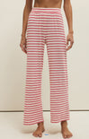 Red and white striped pants worn by a person on a neutral background
