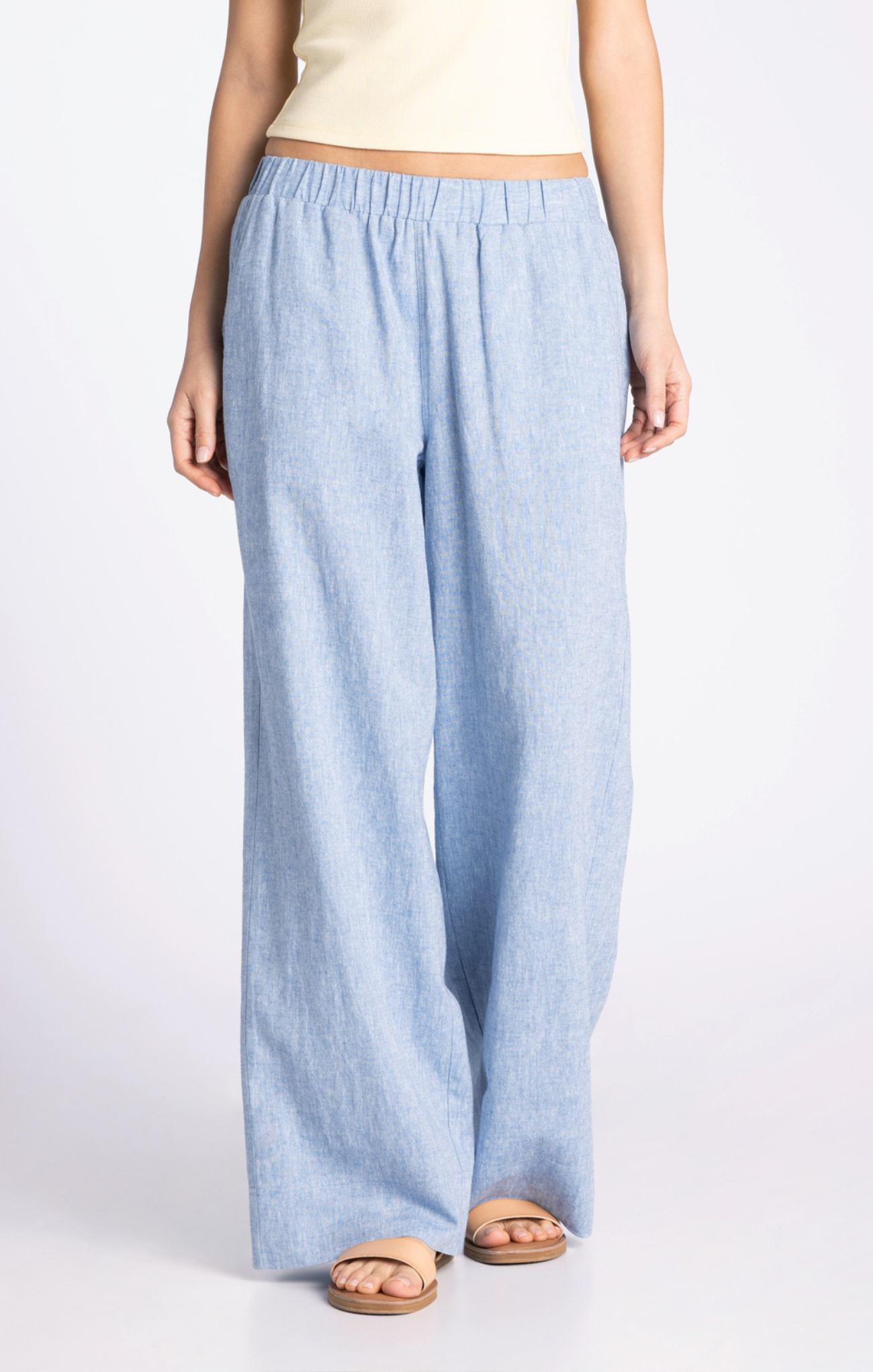 Light blue wide-leg pants worn by a person on a white background