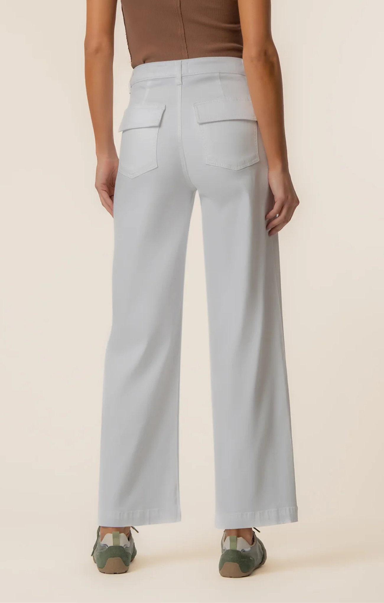 Light blue wide-leg pants worn by a person on a beige background