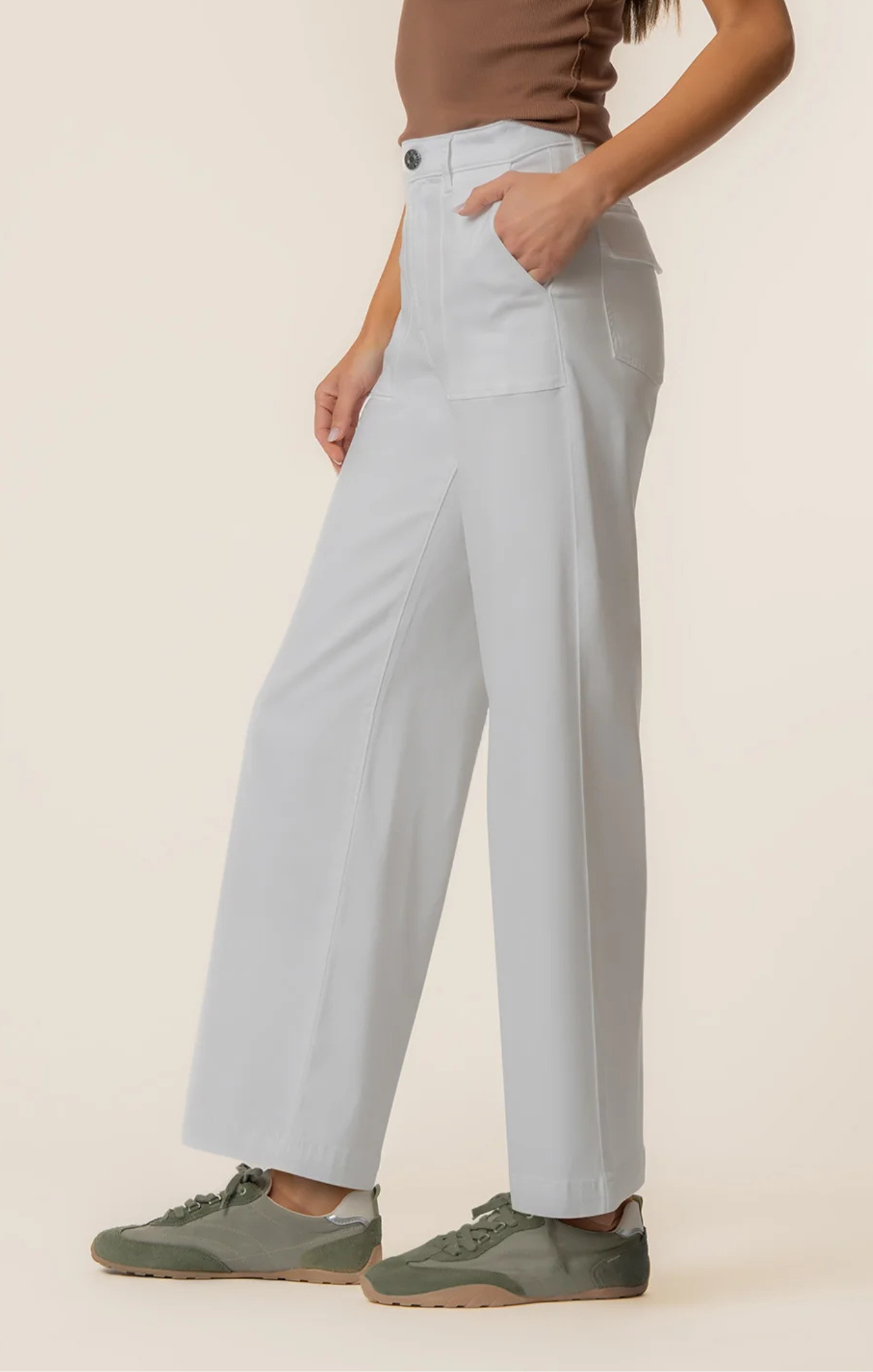 Light blue pants worn by a person on a beige background