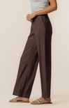 Person wearing brown wide-leg pants on a plain background